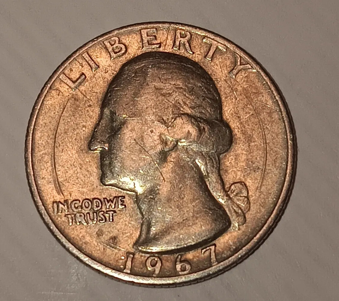 Copper struck mistake on a 25 cents coin.